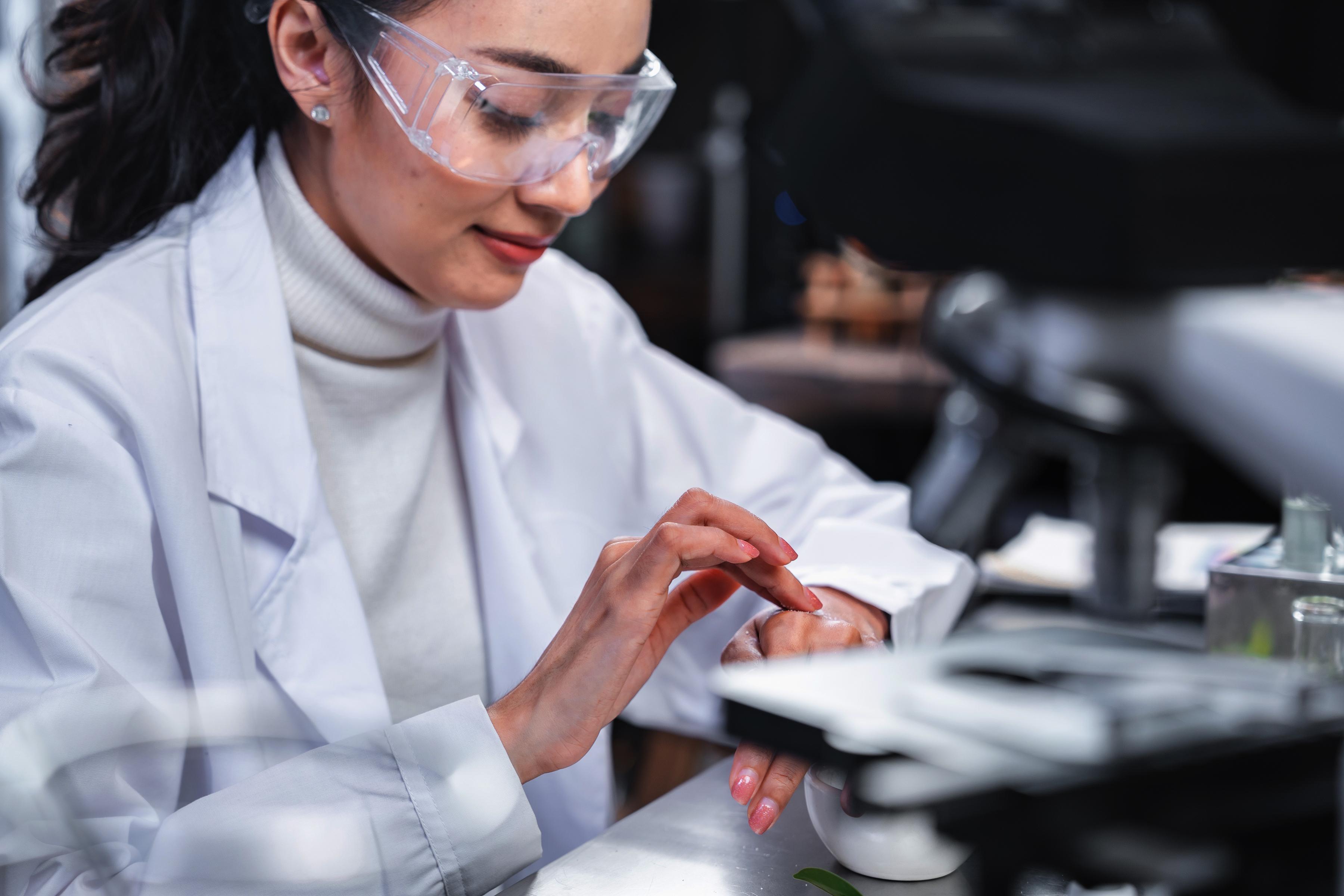 Woman testing cream on her hand